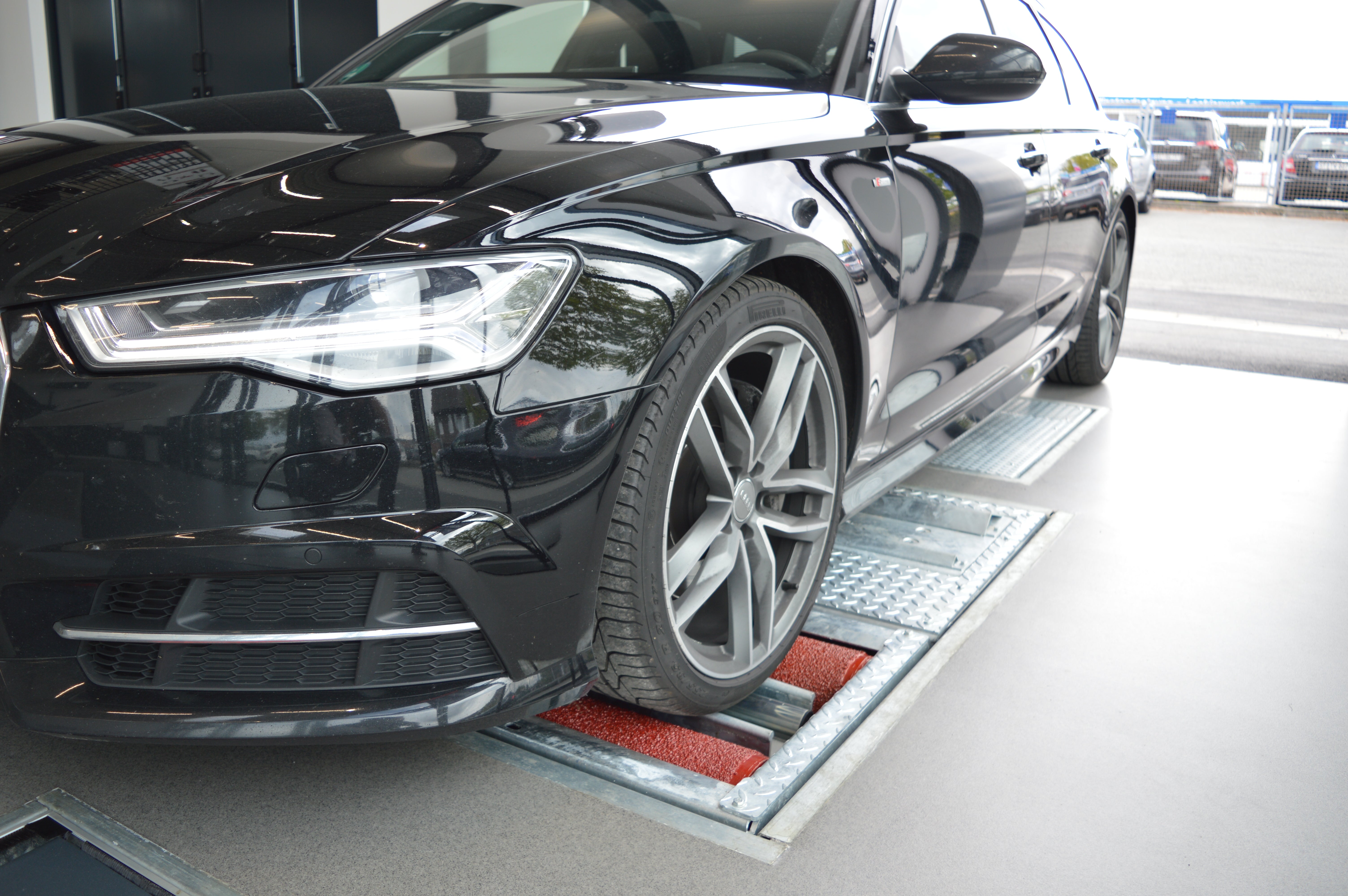 Vehicle positioned on brake testing equipment